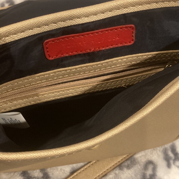 Has a tassel decoration and an adjustable strap. - Picture 2 of 3